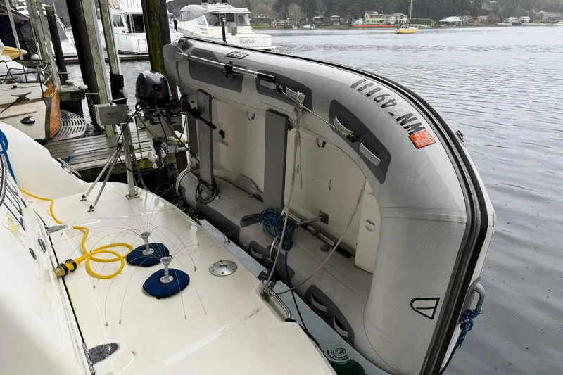Slide: The Image of 2005 Sea Ray 390 Sundancer with inflatable dinghy docked at marina. - 38