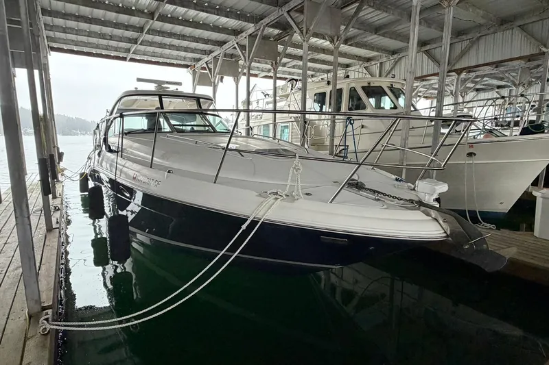 Slide: The Image of 2005 Sea Ray 390 Sundancer docked in a covered marina. - 4