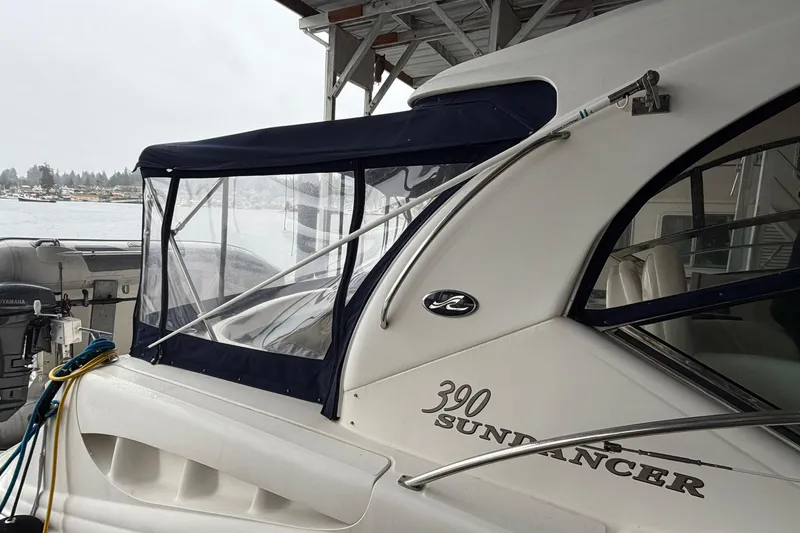 Slide: The Image of 2005 Sea Ray 390 Sundancer yacht docked, featuring sleek design and covered seating area. - 6