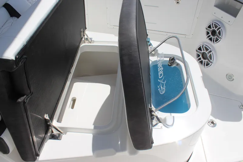 Slide: The Image of 2023 Crevalle 33 CSF boat interior with open storage compartments and speakers. - 11