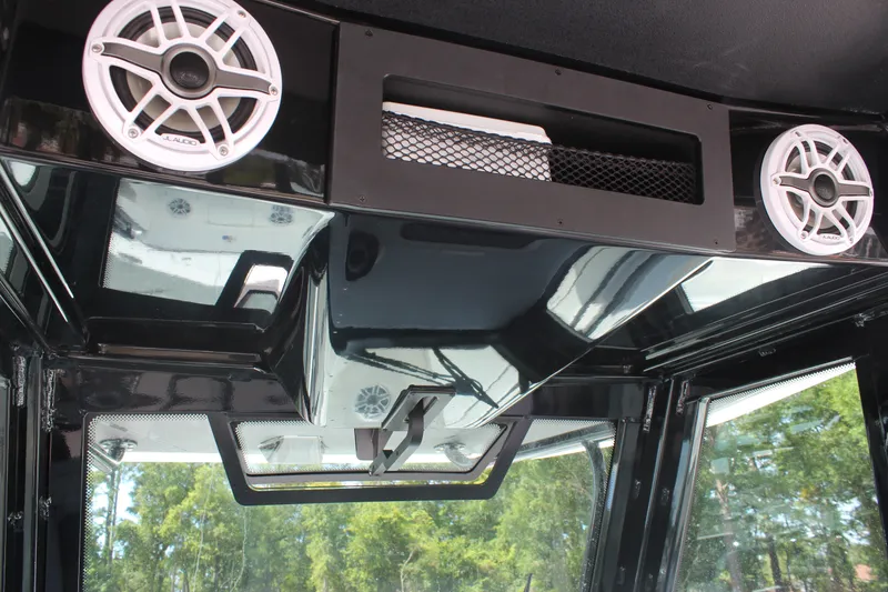 Slide: The Image of 2023 Crevalle 33 CSF boat interior with speakers and sleek black design. - 14