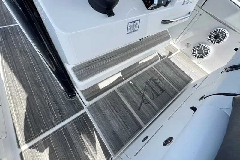 Slide: The Image of 2023 Crevalle 33 CSF boat interior with wood-patterned flooring and speaker system. - 19