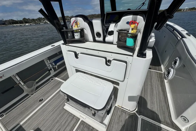 Slide: The Image of 2023 Crevalle 33 CSF boat interior with seating and storage on a sunny day. - 27