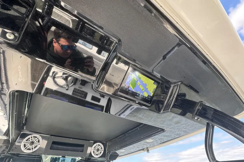 Slide: The Image of 2023 Crevalle 33 CSF boat dashboard with navigation display and reflection. - 28