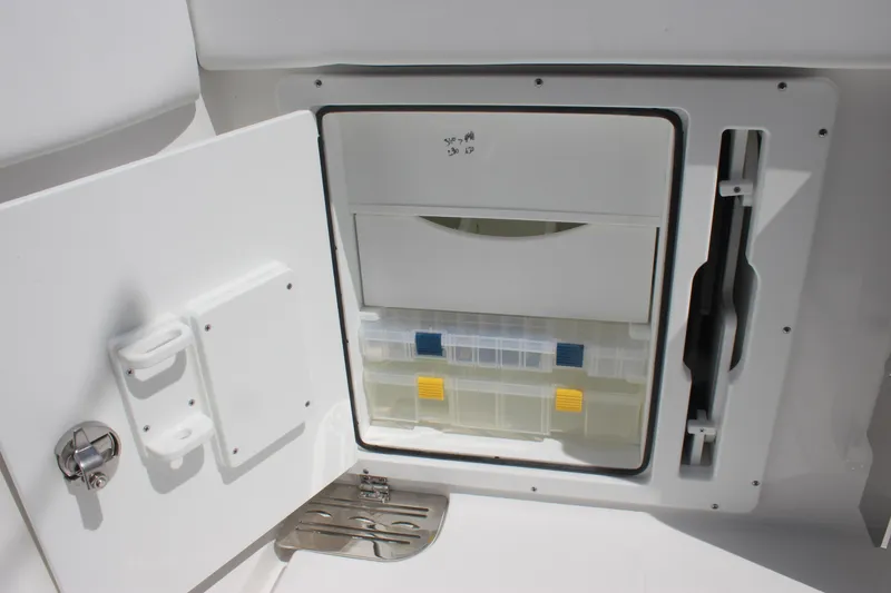 Slide: The Image of Storage compartment on 2023 Crevalle 33 CSF boat, featuring organized tackle boxes. - 29