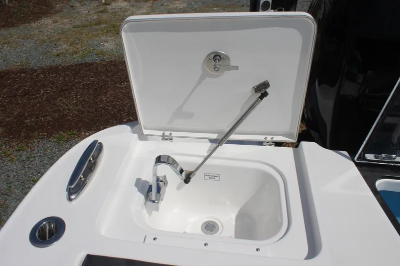 Slide: The Image of 2023 Crevalle 33 CSF boat sink with faucet and storage compartment. - 30
