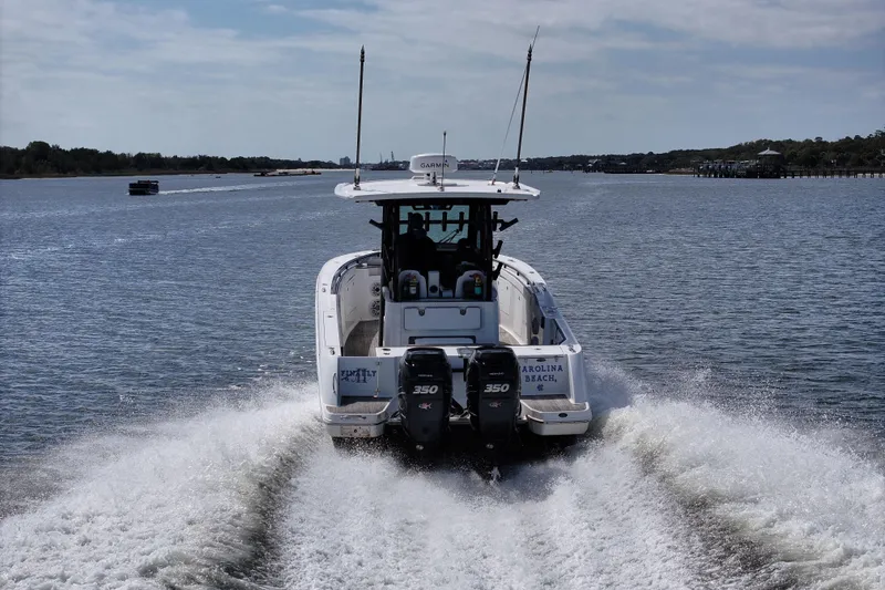 Slide: The Image of 2023 Crevalle 33 CSF boat cruising on a scenic waterway. - 6