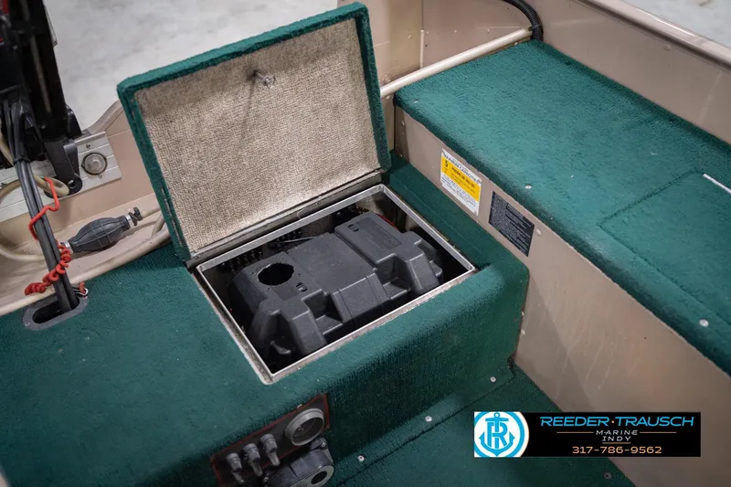Slide: The Image of Open storage compartment in 1999 Lund 1650 Explorer SS boat with green carpet interior. - 22