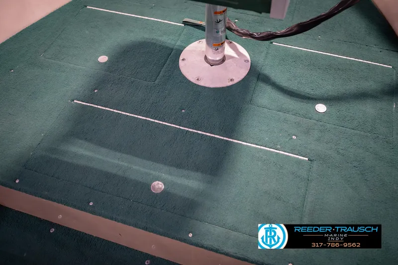 Slide: The Image of Green carpeted deck of a 1999 Lund 1650 Explorer SS boat. - 25