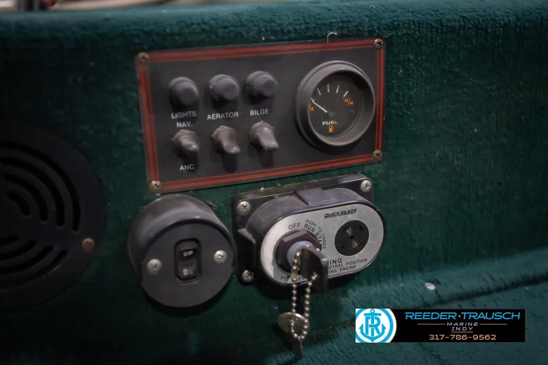 Slide: The Image of Control panel of a 1999 Lund 1650 Explorer SS boat with switches and fuel gauge. - 28