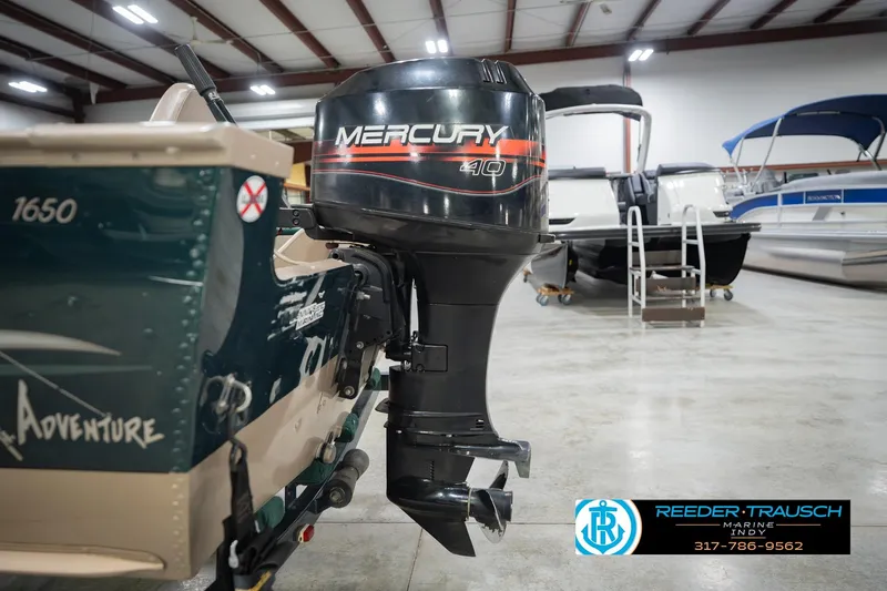 Slide: The Image of 1999 Lund 1650 Explorer SS with Mercury 40 outboard motor in showroom. - 33