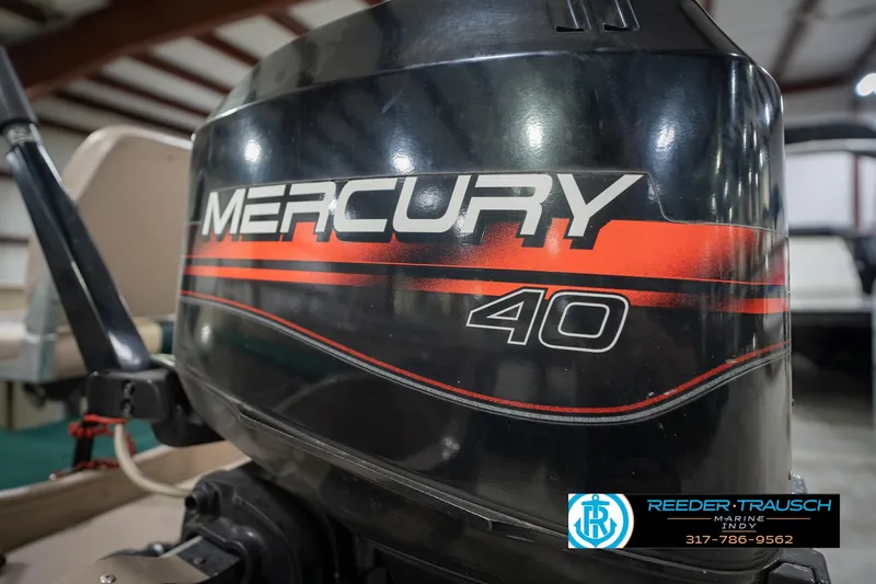 Slide: The Image of 1999 Lund 1650 Explorer SS with Mercury 40 outboard motor in a showroom. - 34
