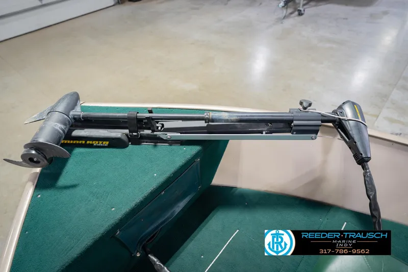 Slide: The Image of 1999 Lund 1650 Explorer SS with Minn Kota trolling motor on green carpeted deck. - 37