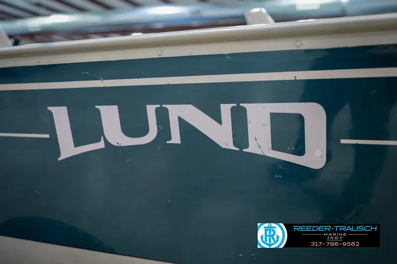 Slide: The Image of 1999 Lund 1650 Explorer SS boat with visible logo and contact information. - 41