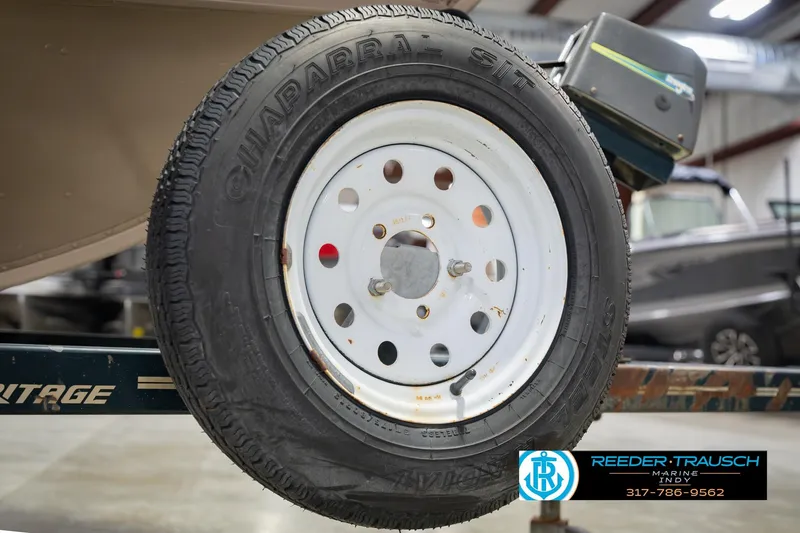 Slide: The Image of Trailer tire of a 1999 Lund 1650 Explorer SS boat in a showroom. - 45