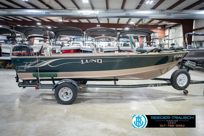 Slide: The Image of 1999 Lund 1650 Explorer SS boat on trailer in indoor showroom. - 6