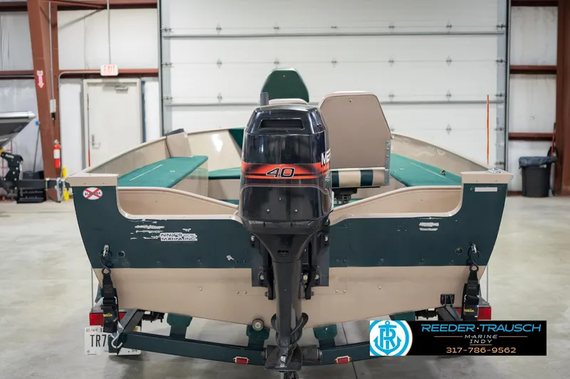 Slide: The Image of 1999 Lund 1650 Explorer SS boat with Mercury 40 outboard motor in a garage setting. - 8