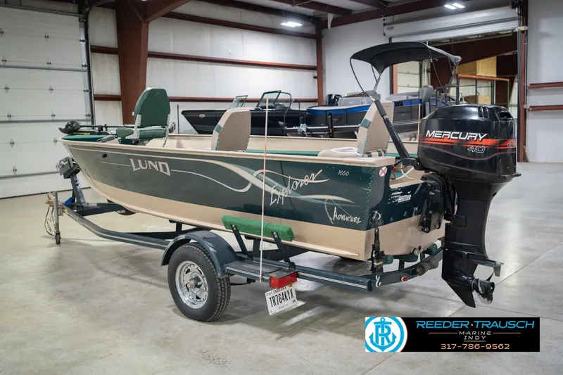 Slide: The Image of 1999 Lund 1650 Explorer SS boat with Mercury 40 engine in showroom. - 9