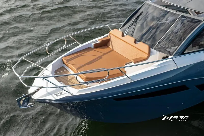 Slide: The Image of 2026 NX Boats NX370 with sleek design and spacious deck on water. - 5