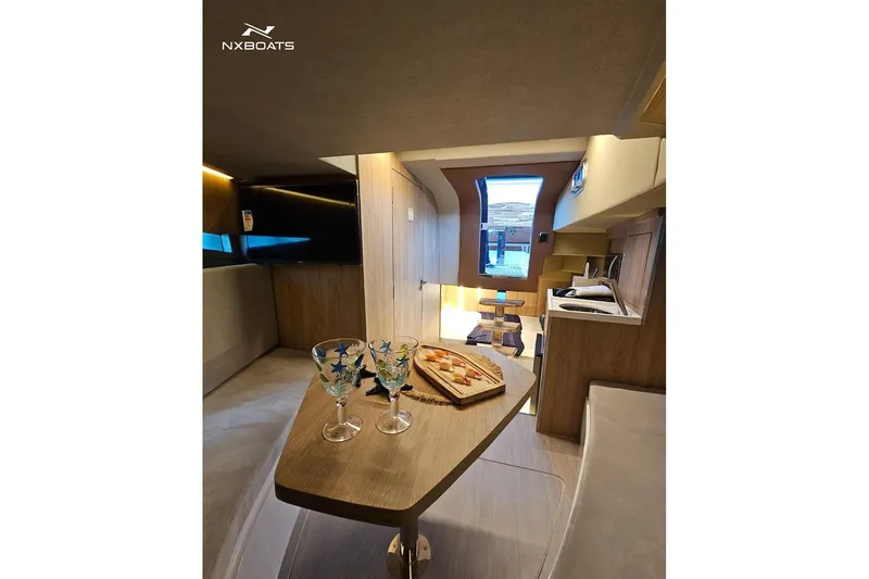 Slide: The Image of Luxurious interior of 2026 NX Boats NX370 with elegant dining setup and modern design. - 9