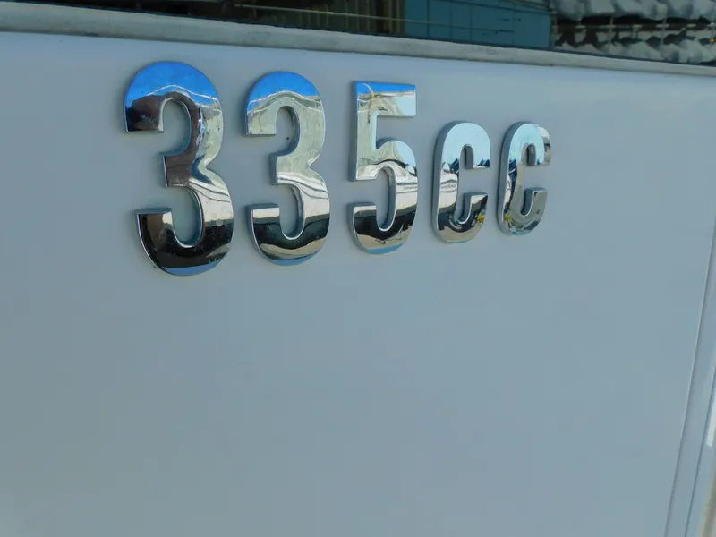 Slide: The Image of 2019 Everglades 335 Center Console on a boat lift. - 2