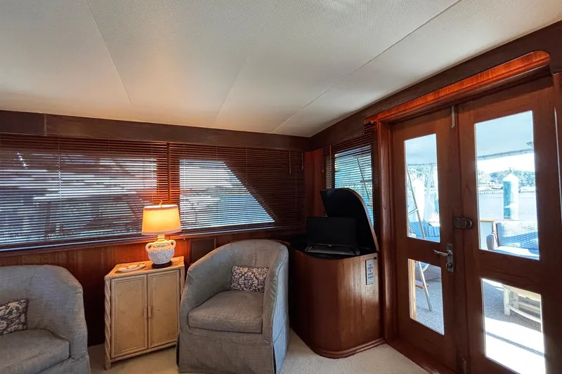 Slide: The Image of Interior of a 1979 Hatteras 53 Motor Yacht with cozy seating and wooden accents. - 10