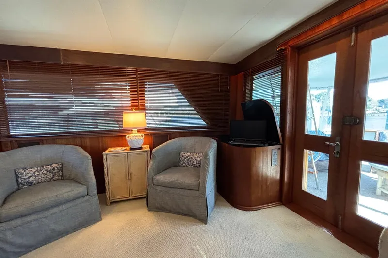 Slide: The Image of Interior of 1979 Hatteras 53 Motor Yacht with cozy seating and wooden accents. - 11