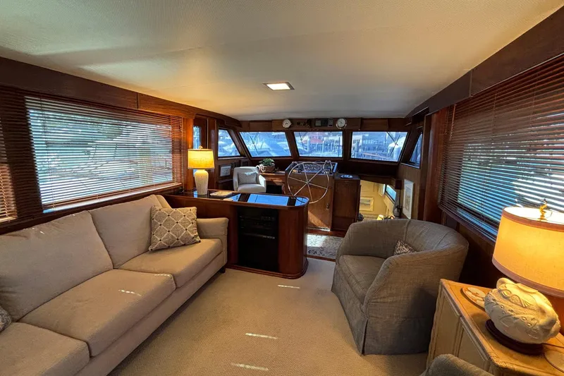 Slide: The Image of Interior of a 1979 Hatteras 53 Motor Yacht with cozy seating and elegant decor. - 12