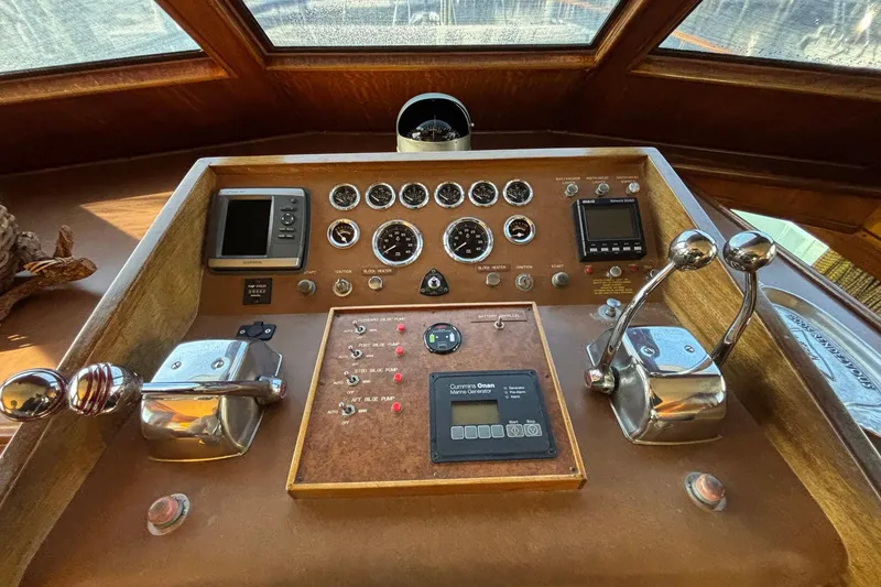 Slide: The Image of 1979 Hatteras 53 Motor Yacht helm with gauges, controls, and navigation equipment. - 14