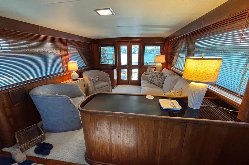 Slide: The Image of Interior of a 1979 Hatteras 53 Motor Yacht with cozy seating and warm lighting. - 15