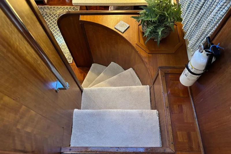 Slide: The Image of Staircase inside 1979 Hatteras 53 Motor Yacht with carpet and wooden finish. - 16