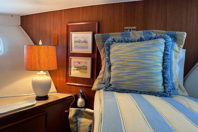 Slide: The Image of Cozy cabin interior of 1979 Hatteras 53 Motor Yacht with striped bedding and lamp. - 22
