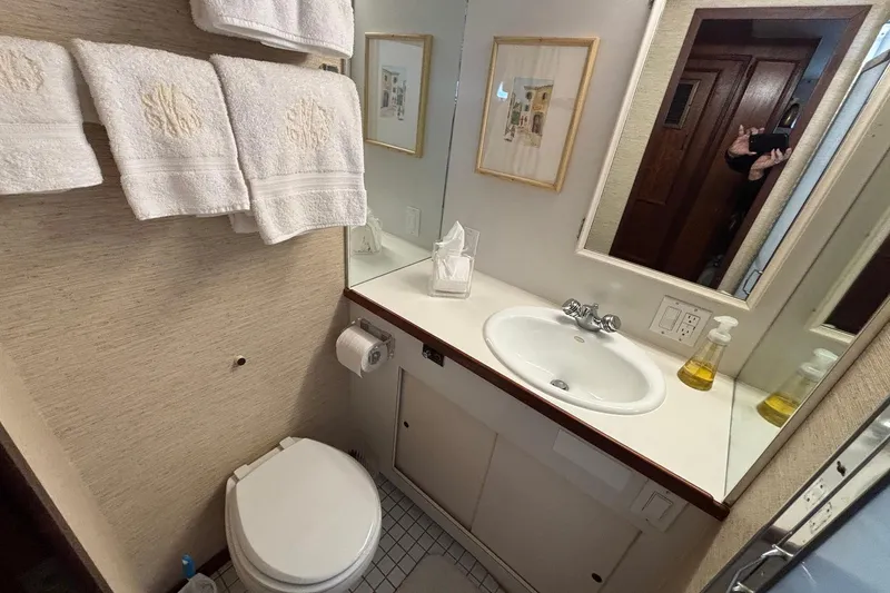 Slide: The Image of Bathroom interior of 1979 Hatteras 53 Motor Yacht with sink, mirror, and towels. - 26