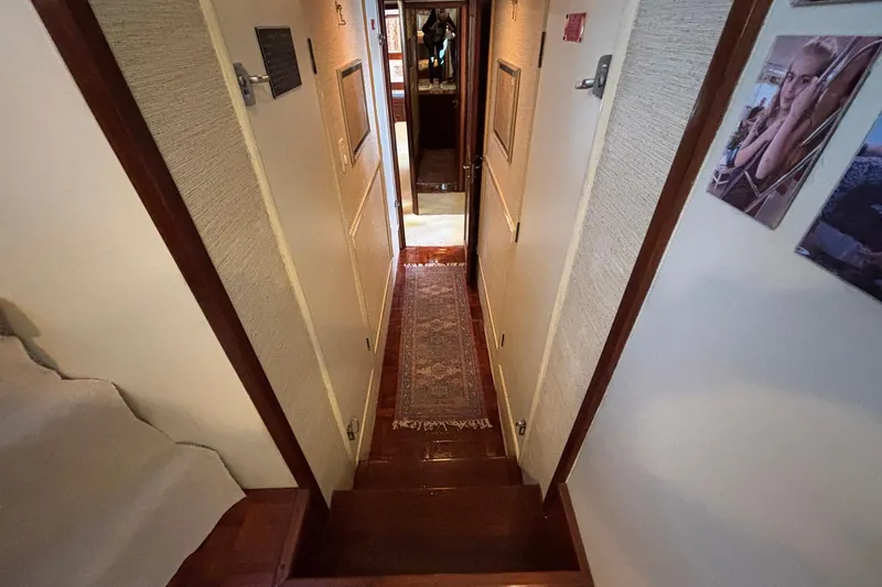 Slide: The Image of Interior hallway of a 1979 Hatteras 53 Motor Yacht with wooden steps and decor. - 29