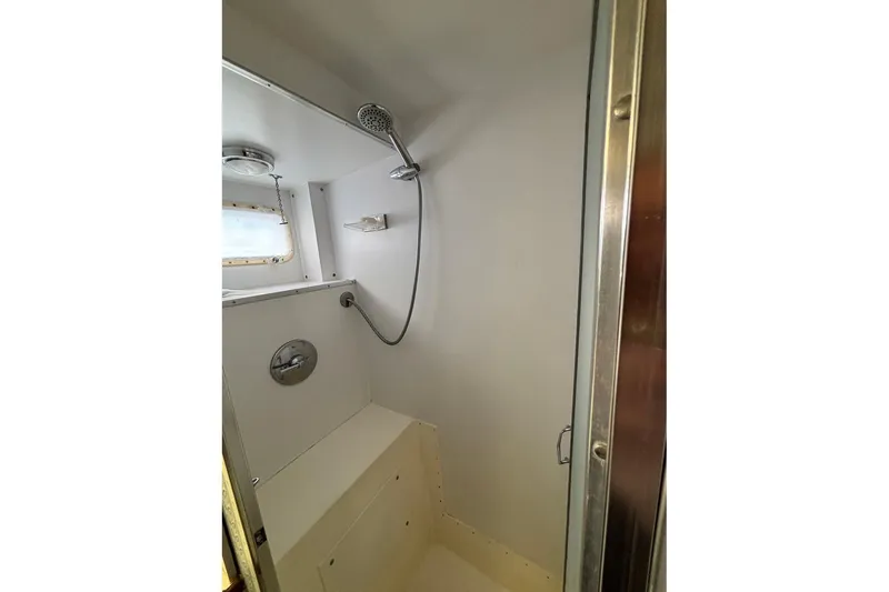 Slide: The Image of Shower area inside a 1979 Hatteras 53 Motor Yacht, featuring a handheld showerhead. - 31