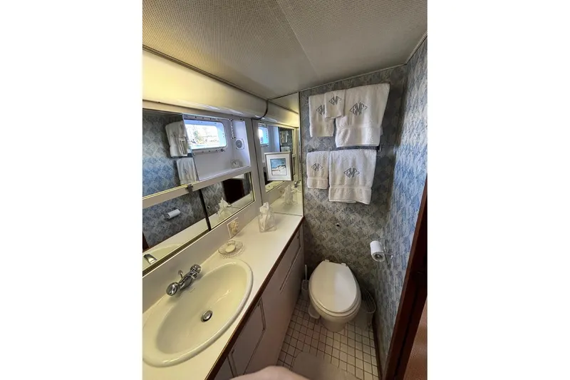 Slide: The Image of Bathroom interior of 1979 Hatteras 53 Motor Yacht with sink, toilet, and towels. - 34