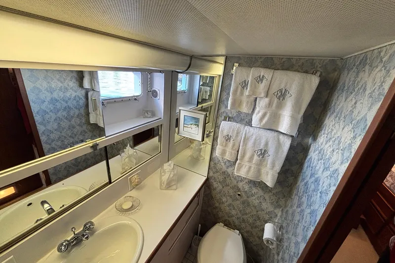 Slide: The Image of Bathroom interior of 1979 Hatteras 53 Motor Yacht with sink, mirror, and towels. - 35