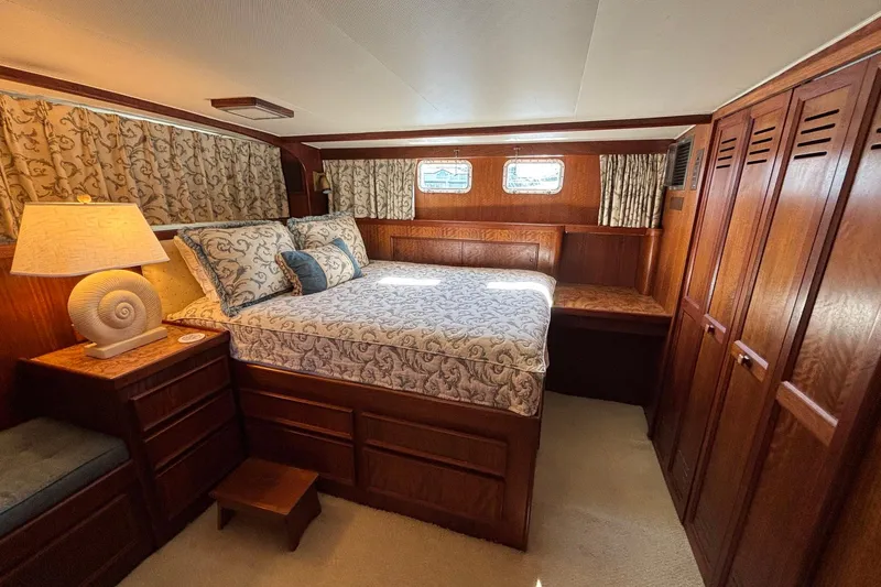 Slide: The Image of Luxurious bedroom interior of a 1979 Hatteras 53 Motor Yacht with elegant wood finishes. - 36