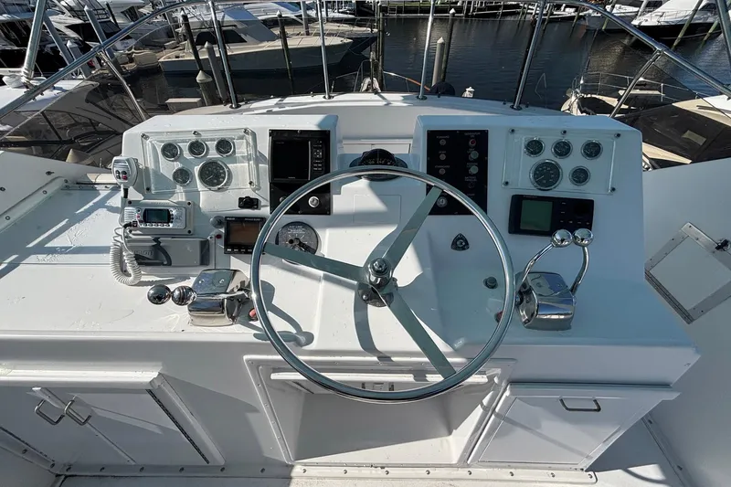 Slide: The Image of 1979 Hatteras 53 Motor Yacht helm with steering wheel and navigation instruments. - 40