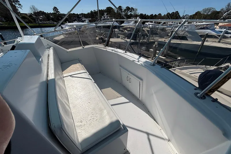 Slide: The Image of 1979 Hatteras 53 Motor Yacht deck with seating area and marina view. - 41
