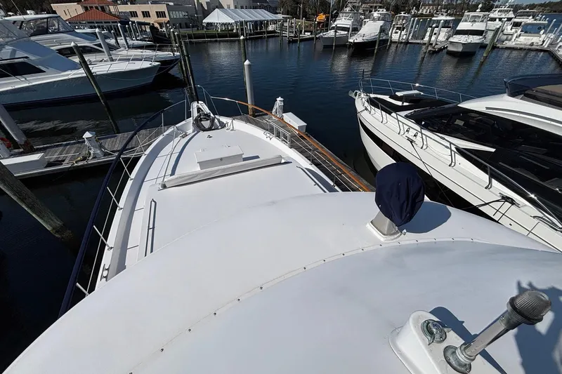 Slide: The Image of 1979 Hatteras 53 Motor Yacht docked in a marina with other boats. - 43
