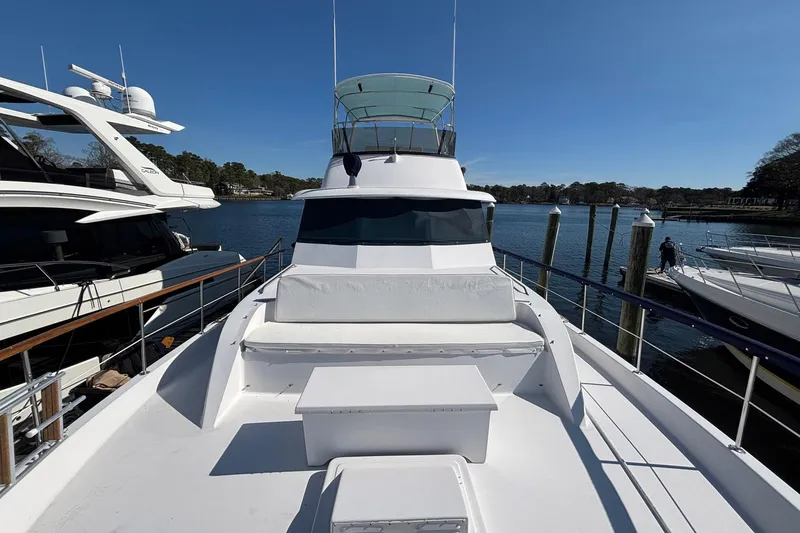 Slide: The Image of 1979 Hatteras 53 Motor Yacht docked, showcasing spacious deck and sleek design. - 50
