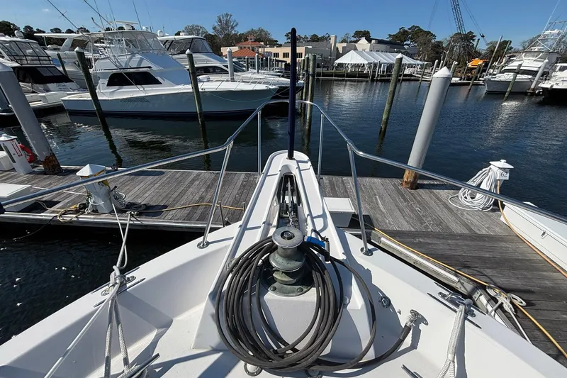 Slide: The Image of Bow view of a 1979 Hatteras 53 Motor Yacht docked at a marina. - 52