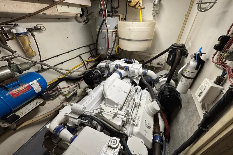 Slide: The Image of Engine room of a 1979 Hatteras 53 Motor Yacht with visible machinery and equipment. - 57