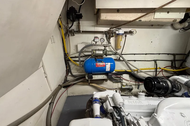 Slide: The Image of Engine room of a 1979 Hatteras 53 Motor Yacht with visible machinery and piping. - 58