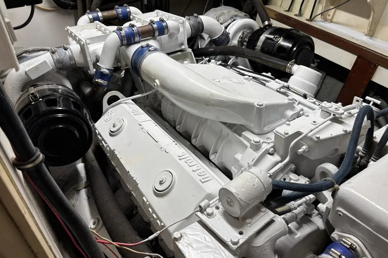 Slide: The Image of Engine room of a 1979 Hatteras 53 Motor Yacht, showcasing a well-maintained engine. - 62