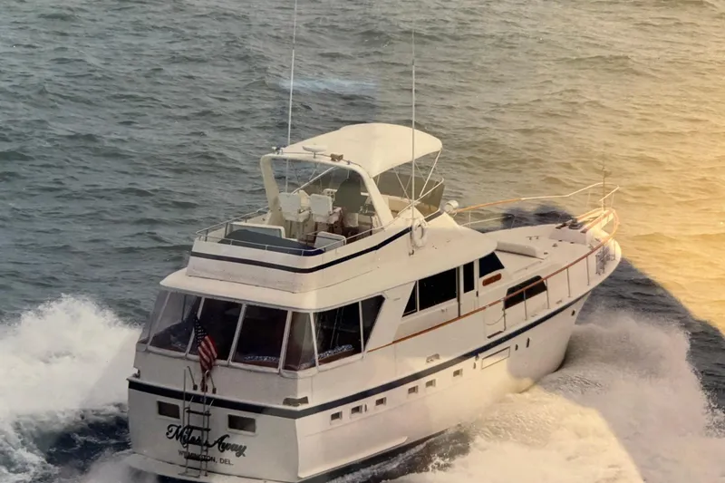 Slide: The Image of 1979 Hatteras 53 Motor Yacht cruising on open water, rear view. - 64
