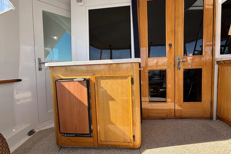 Slide: The Image of 1979 Hatteras 53 Motor Yacht interior with wooden cabinetry and glass doors. - 8