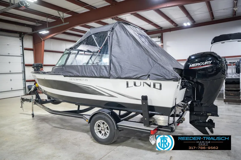 Slide: The Image of 2022 Lund 1875 Impact boat with Mercury engine in indoor showroom. - 10