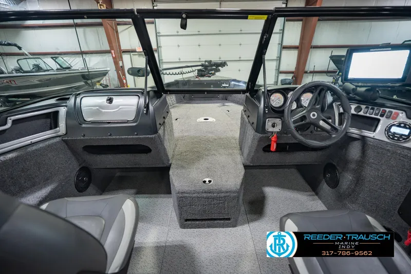 Slide: The Image of 2022 Lund 1875 Impact boat interior with steering wheel and dashboard controls. - 17